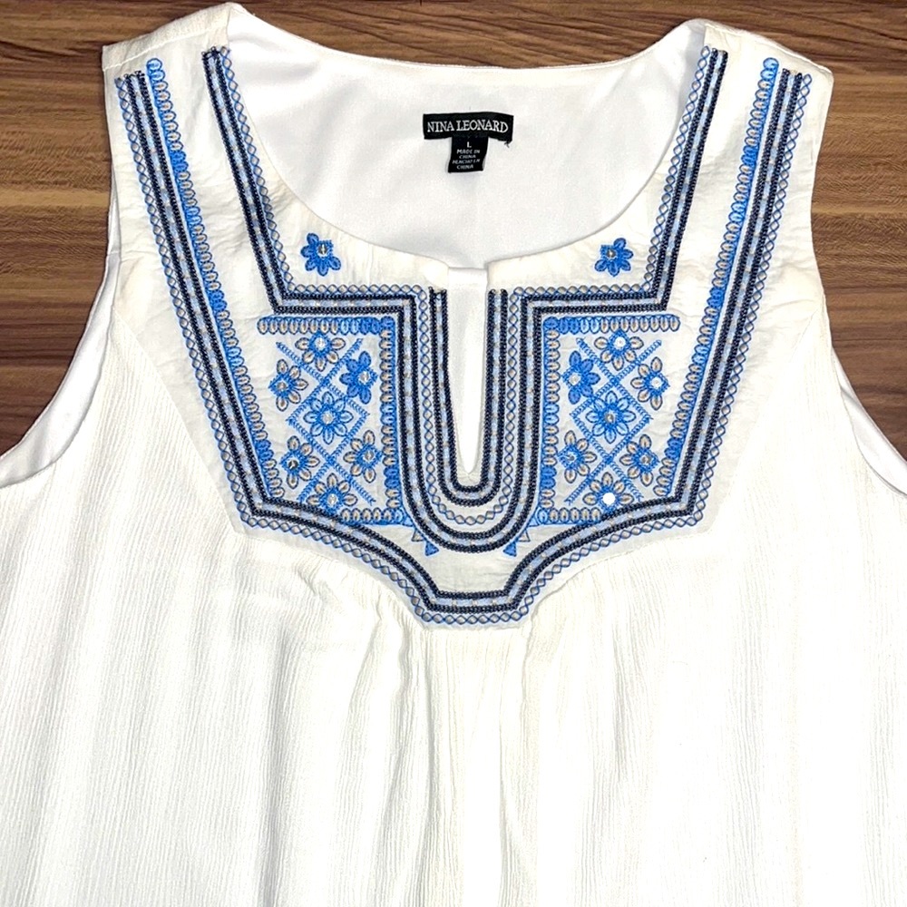 White dress with blue floral design.